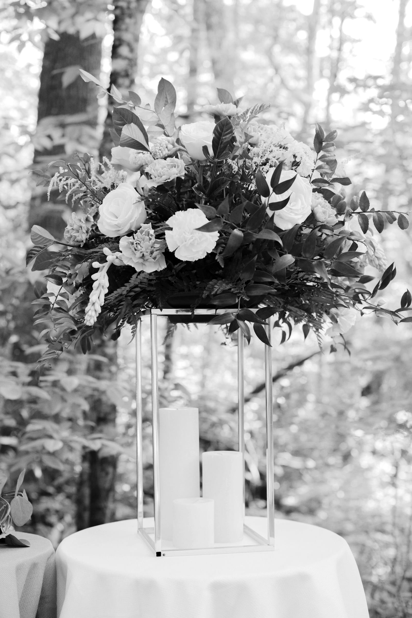 Tall floral centrepiece on a stand at an elegant event